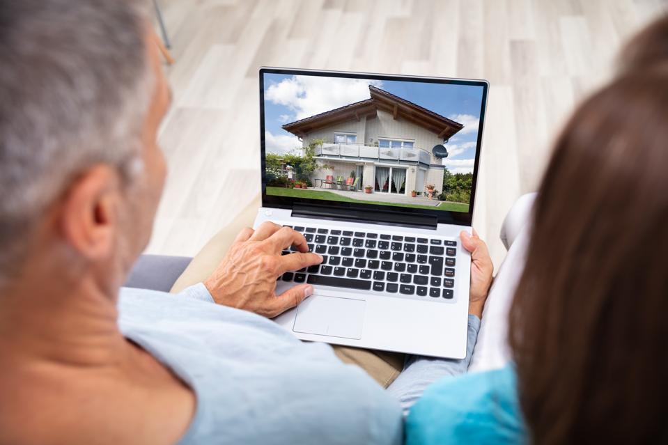 Couple Looking At House