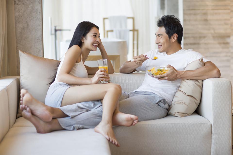 Happy young couple sitting on the sofa