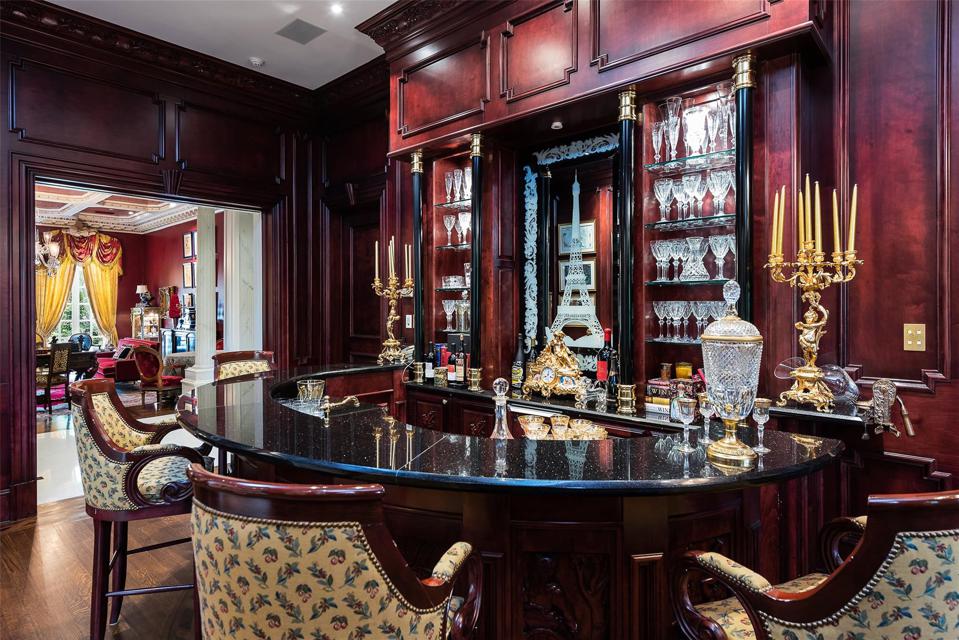 Mahogany bar with wine cellar underfoot.