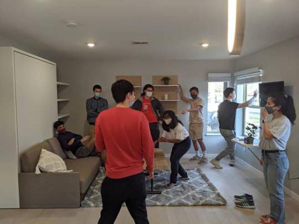 Students from the University of Illinois work together to put the finishing touches on their project.