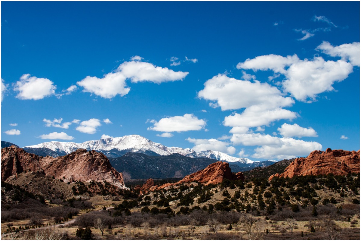 Three orange peaks with a cloudy sky